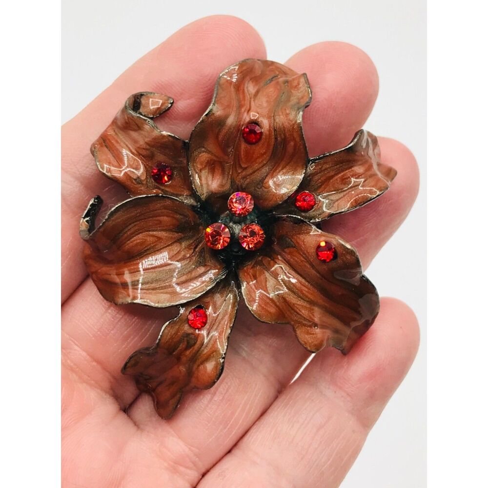 Vintage swirled brown red enamel coral & red rhinestone flower brooch.